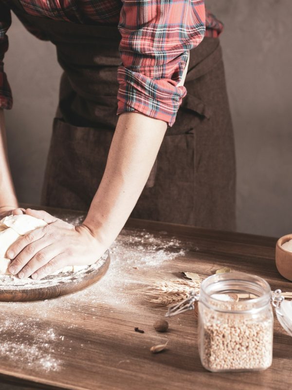 Baker man making dough and bakery ingredients for homemade bread cooking on table. Bakery concept